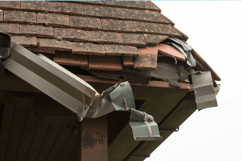 Storm-damaged roof with missing shingles